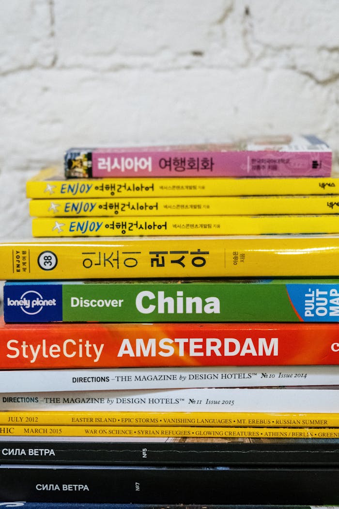 A colorful stack of travel guides and language books for global explorers.